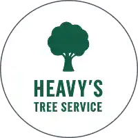 Heavy's Tree Service logo featuring a deciduous tree inside a saw blade.